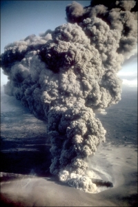 Phreatomagmatic eruption column rising from the East Ukinrek Maar crater at about 5:00 PM on April 6, 1977. View is to the SE. At the peak of the eruption ash plumes reached up to 6 km above the vent. On the 4th day of the eruption a lava dome appeared within East Maar which is now covered by lake water. April 6, 1977. (Photo: R. Russell)
