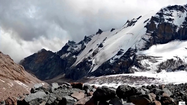 Rocky volcanic landscape at the southern slope of Kazbek, with presumably a collapsed crater on the right. (© Grzegorz Gawlik; screenshot from video below)